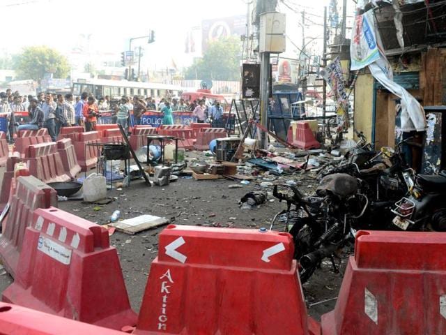 One of the blast sites in Hyderabad is cordoned off as police and pedestrians look on. The busy Dilsukhnagar is limping back to life as shopkeepers and roadside vendors resumed their business. AFP/Indranil Mukherjee