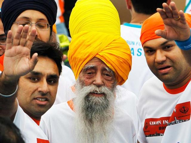 Marathon runner Fauja Singh, 101, center, originally from Beas Pind, in Jalandhar, now living in London, runs in a 10-kilometer race, part of the annual Hong Kong Marathon. Singh retired from public racing after competing in the marathon. AP photo