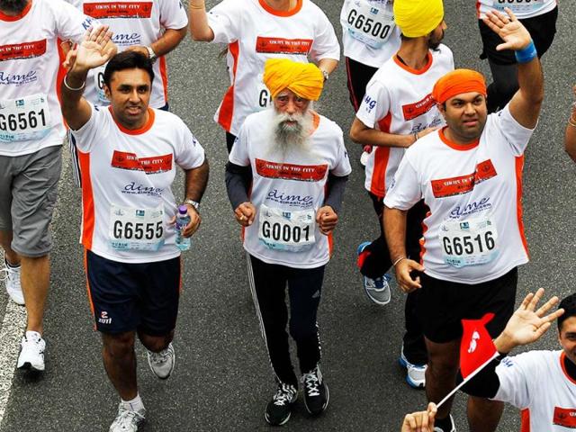 Marathon runner Fauja Singh, 101, center, originally from Beas Pind, in Jalandhar, now living in London, runs in a 10-kilometer race, part of the annual Hong Kong Marathon, in Hong Kong. Singh retired from public racing after competing in the marathon. AP photo
