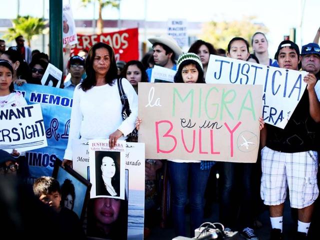 Protesters show support for victims killed by Border Patrol agents during a rally at the US-Mexico border in San Ysidro, California. (Reuters)
