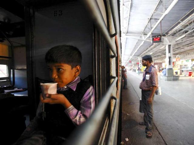 A boy drinks tea inside a train at Agra Cantt Railway Station. (Reuters)