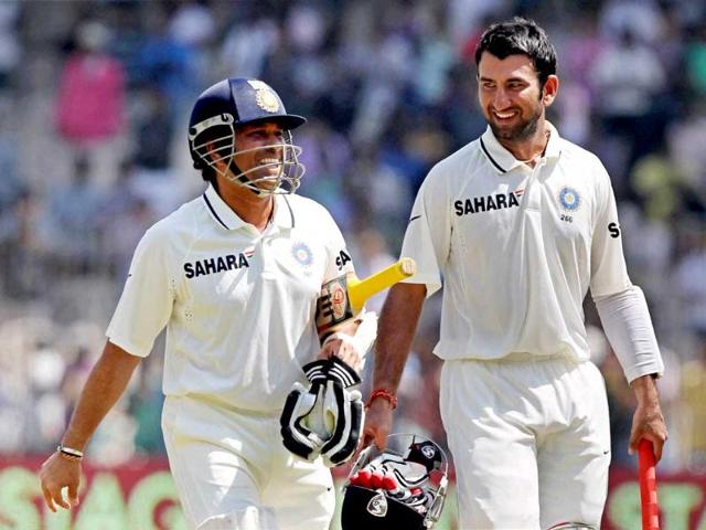 Sachin Tendulkar and C Pujara walk back to pavilion after their win over Australia in the first Test match at MA Chidambaram Stadium in Chennai. PTI photo