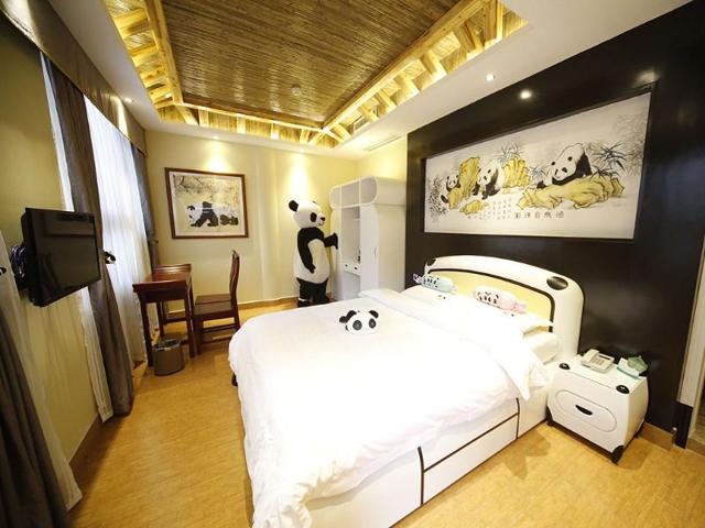 An employee wearing a panda suit introducing the rooms in a panda-themed hotel at the foot of Emei Mountain in Emeishan, southwest China's Sichuan province. The hotel is reportedly the first panda-themed hotel in the world. AFP