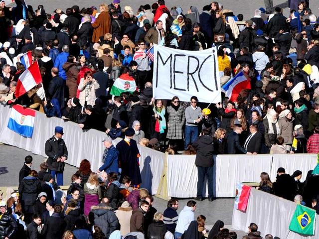 Faithful gather on St Peter's square ahead of Pope Benedict XVI last weekly audience at the Vatican. Tens of thousands of emotional pilgrims cheered and whooped he rode out in his white "popemobile". AFP/Tiziana Fabi