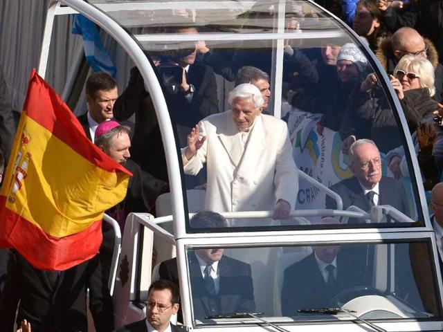 Pope Benedict XVI waves as he arrives on St Peter's square for his last weekly audience. He bid an emotional farewell at his last general audience acknowledging the "rough seas" that marked his papacy "when it seemed that the Lord was sleeping." AFP/Alberto Pizzoli