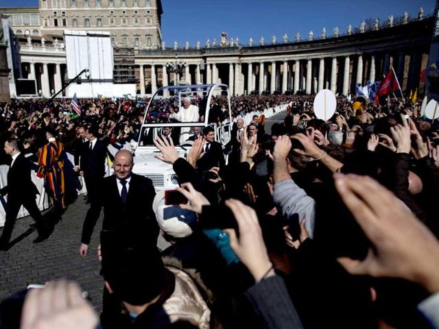 Pope Benedict XVI waves from his pope-mobile as he is driven through the crowd during his last general audience in St Peter's Square, at the Vatican. Benedict thanked his cardinals, colleagues and ordinary faithful for their support and for respecting his decision to become the first pope in 600 years to resign. AP/Oded Balilty