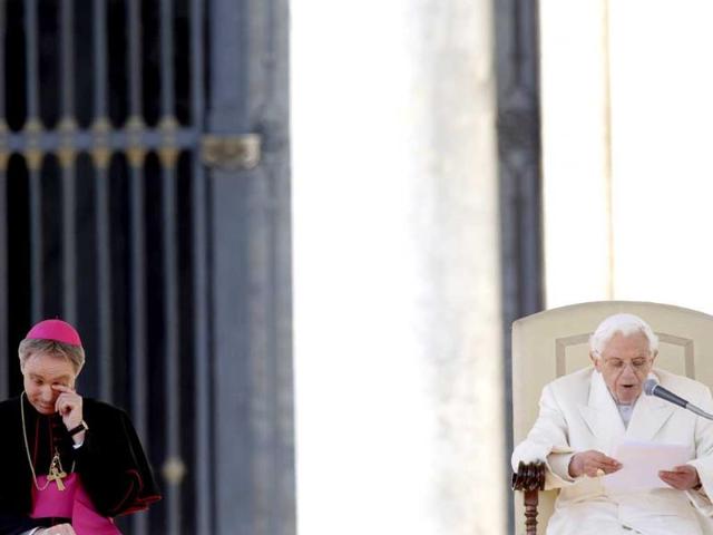 Pope Benedict XVI's personal secretary George Gaenswein wipes his eye as the Pope delivers his message during his last general audience. He thanked his flock for respecting his decision to retire. AP/Gregorio Borgia