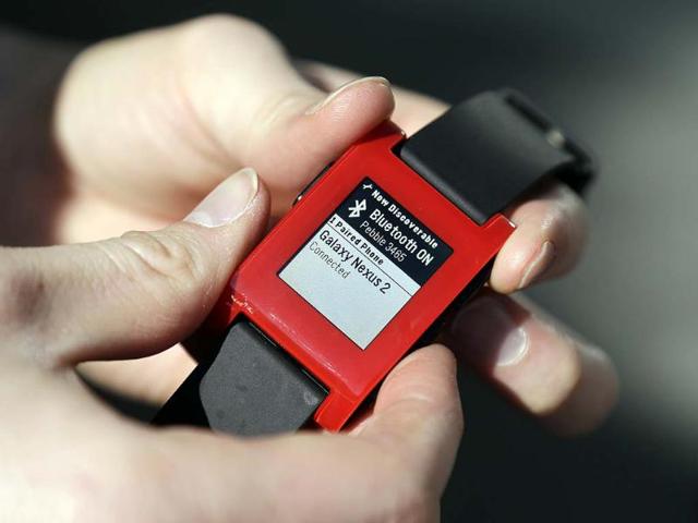 Eric-Migicovsky-CEO-of-Pebble-displays-his-company-s-smart-watch-in-Palo-Alto-Calif-Tuesday-Feb-12-2013-This-new-watch-not-only-tells-time-but-also-connect-to-smart-phones-within-10-meters-Photo-AP-Marcio-Jose-Sanchez