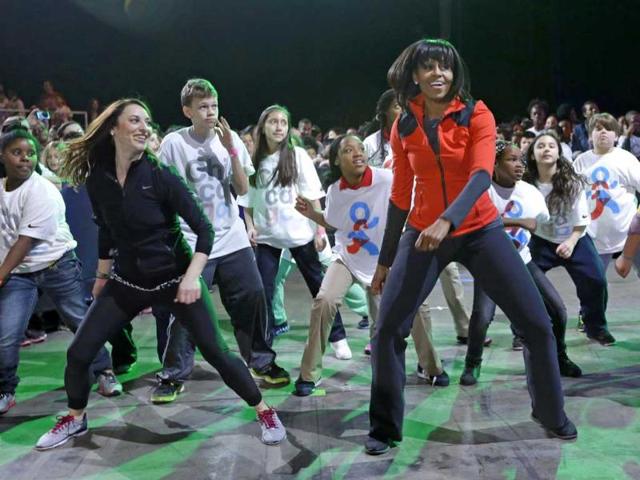 First lady Michelle Obama exercises with children from Chicago Public Schools, as she makes a major announcement helping to bring back physical activity to area schools, while celebrating the third anniversary of her 'Lets Move' program in Chicago. AP/M Spencer Green