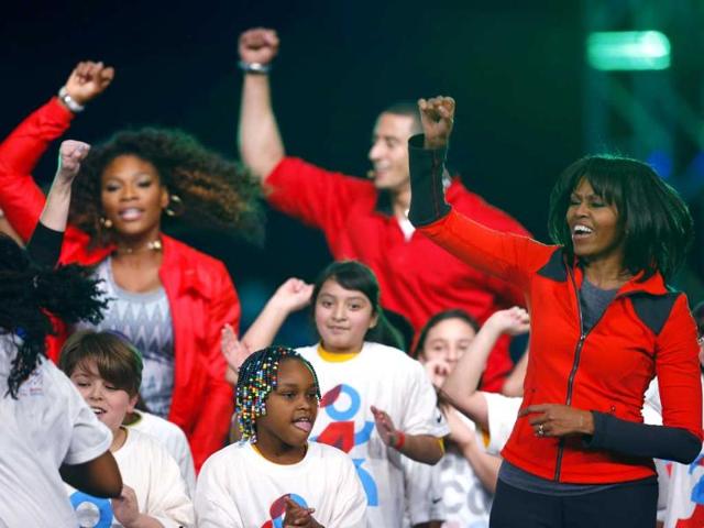 Tennis player Serena Williams, San Francisco 49ers quarterback Colin Kaepernick and US first lady Michelle Obama dance on stage with school children during an event to bring physical activity back to schools, in Chicago, Illinois. Reuters/Jeff Haynes