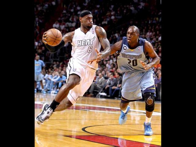 Miami Heat's LeBron James, left, drives against Memphis Grizzlies' Quincy Pondexter during the first quarter of an NBA basketball game in Miami. AP Photo