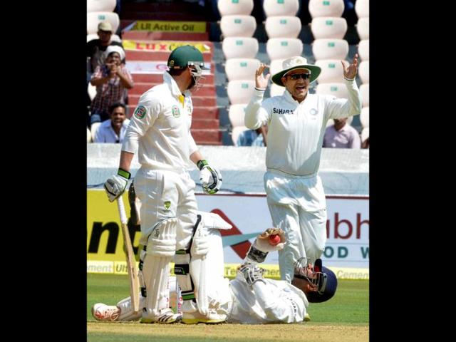 Virender Sehwag celebrates the dismissal of Australia's P Hughes during the 2nd cricket Test match in Hyderabad. (PTI Photo)