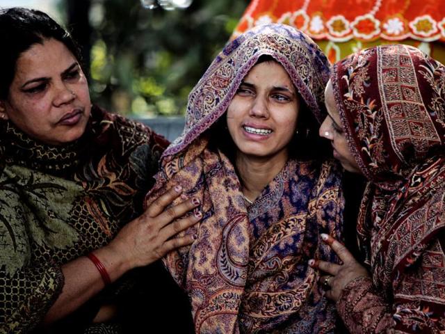 Yogita, the mother of two children whose bodies were found at Pragati Maidan, is consoled by two women. HT/M Zhazo