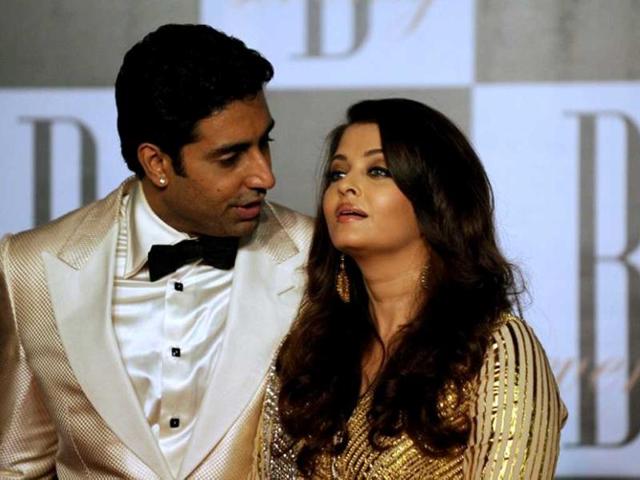 Abhishek Bachchan (L) speaks with wife and actress Aishwarya Rai-Bachchan as they pose during a party on the eve of Amitabh Bachchan's 70th birthday in Mumbai on October 10, 2012. AFP Photo