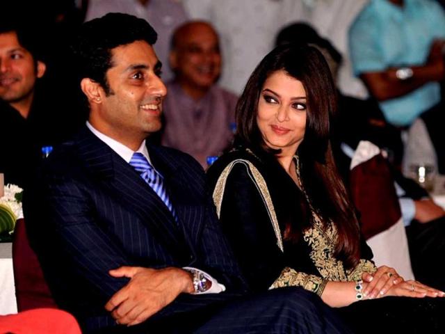 Abhishek Bachchan (L) and his wife Bollywood film actress, Aishwarya Rai Bachchan attend the unveiling of the book My Father, Our Fraternity. AFP Photo