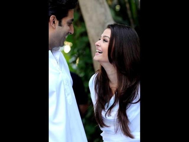 Abhishek Bachchan and wife Aishwarya Rai share a light moment during a press conference in Mumbai on February 9, 2013. AFP Photo