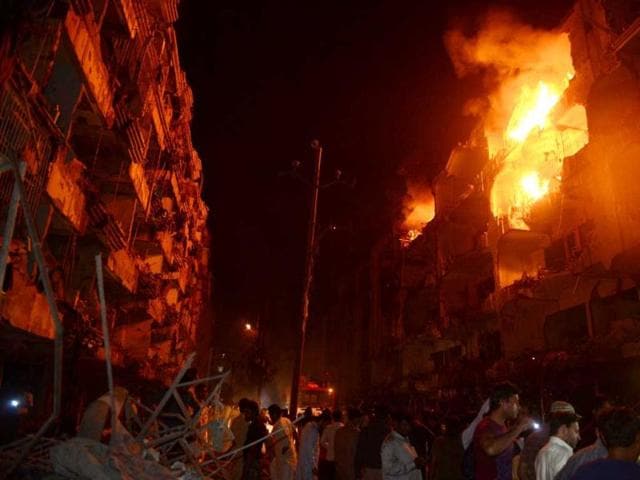 Pakistani residents gather after the bomb blast in Karachi. (AFP)