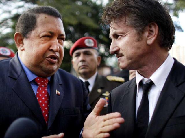 Venezuela's President Hugo Chavez, talks to US actor Sean Penn at the presidential palace in Caracas, Venezuela. (AP)