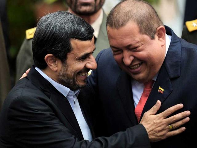 Venezuelan President Hugo Chavez and his Iranian counterpart Mahmoud Ahmadinejad, smile at Miraflores presidential palace in Caracas. (AFP)