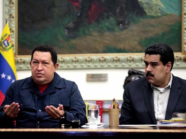 Venezuala's President Hugo Chavez gesturing as he sits next to Vice President Nicolas Maduro during a televised radio event in Caracas. (AFP/Presidencia)