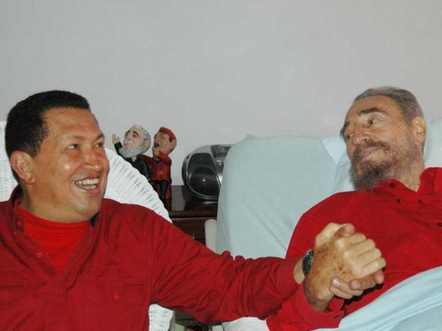 Cuba's leader Fidel Castro, and Hugo Chavez hold hands as Castro recuperates from surgery in Havana, Cuba. (AP)