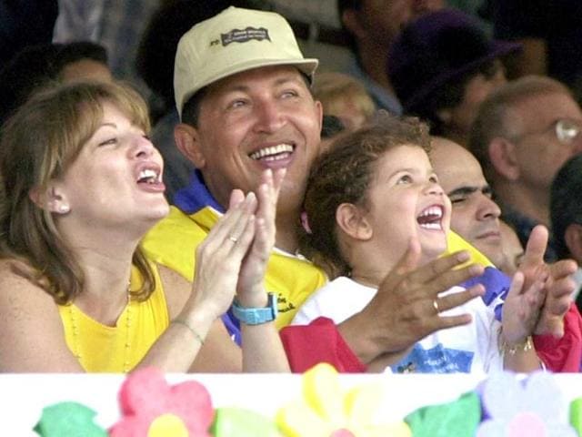 Venezuela's President Hugo Chavez his wife Marisabel with their daughter Rosa Ines watch a parade on Children's Day in Caracas, Venezuela. (AP)