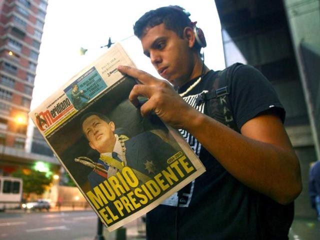 A youngster reads a local newspaper the day after the death of Venezuelan President Hugo Chavez in Caracas. AFP photo