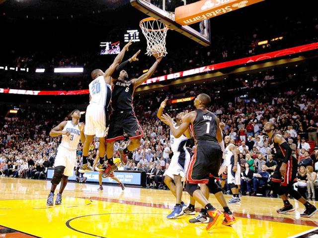 LeBron James #6 of the Miami Heat scores with a driving lay up with 3.2 seconds left in the fourth quarter past DeQuan Jones #20 of the Orlando Magic at American Airlines Arena in Miami, Florida. (AFP)