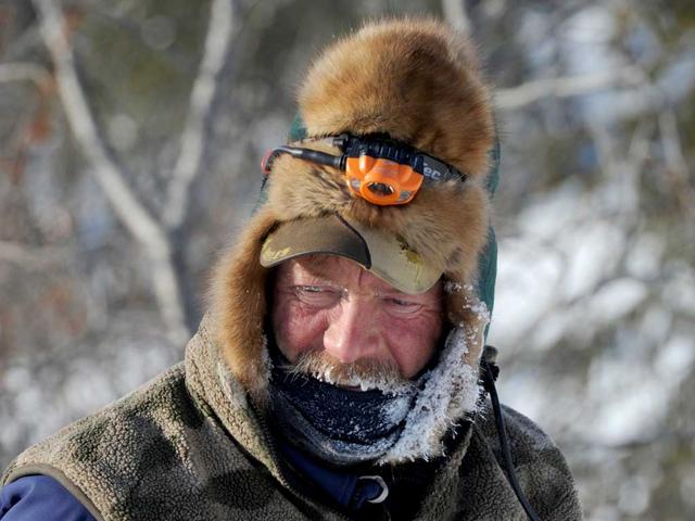 A frost covered Sonny Lindner begins his checkpoint routine in Koyuk. AP photo/Bill Roth