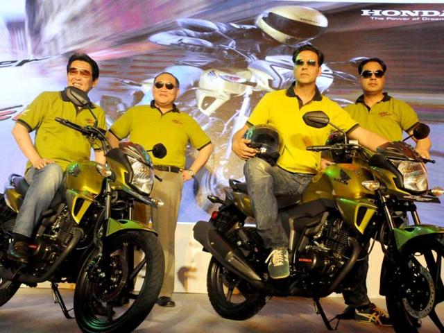 Akshay Kumar poses sitting on the brand new bike. (Photo by Parveen Kumar/Hindustan Times)