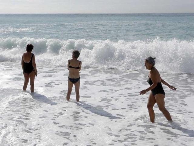 People take a bath in the Mediterranean sea in the southeastern French city of Nice, as a heavy snow storm hit France. (AFP)