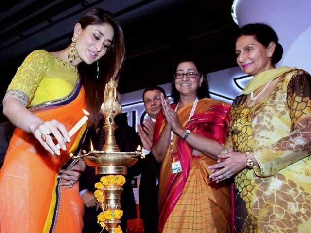 Kareena Kapoor lights a lamp in the presence of Preneet Kaur, Union minister of state for external affairs (R) and Naina Lal Kidwai, President of FICCI during the inaugural ceremony of FICCI Frames 2013 in Mumbai on Tuesday. (PTI Photo)