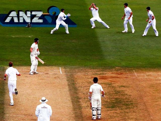England's captain Cook catches New Zealand's Rutherford for 23 runs during the second day of the second Test at the Basin Reserve in Wellington. (Reuters)