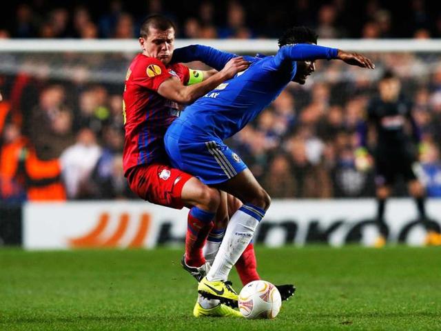 Steaua Bucharest's Bourceanu challenges Chelsea's Obi Mikel during their Europa League soccer match at Stamford Bridge in London. (Reuters)