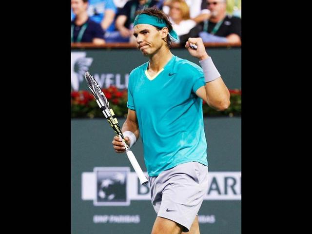 Nadal of Spain celebrates defeating Switzerland's Federer in their men's singles quarterfinal match at the BNP Paribas Open ATP tennis tournament in Indian Wells. (Reuters)