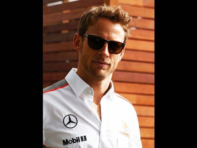 McLaren Formula One driver Jenson Button of Britain arrives during the first practice session of the Australian F1 Grand Prix at the Albert Park circuit in Melbourne. (Reuters)