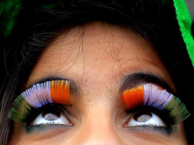 A woman wears false flag eyelashes during the St Patrick's day parade through Dublin city centre on St Patrick's day. (AP)
