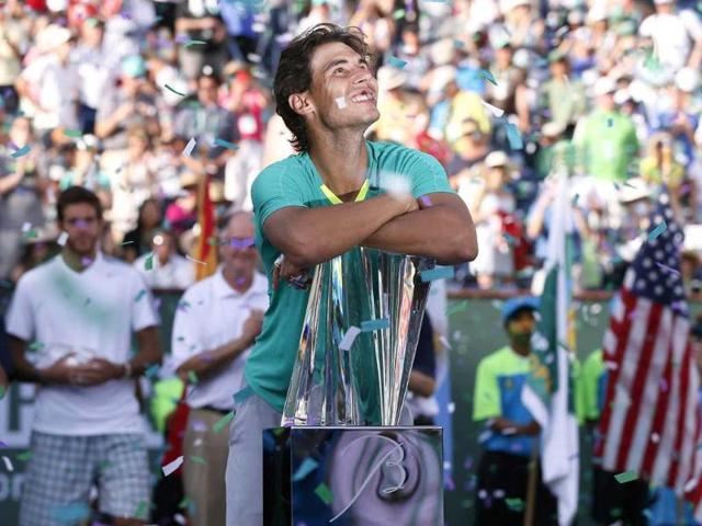 Rafael Nadal of Spain smiles as he leans on his trophy, while confetti flutters in the air, after he defeated Juan Martin Del Potro of Argentina in the men's singles final match to win the BNP Paribas Open ATP tennis tournament in Indian Wells, California. Reuters/UNI