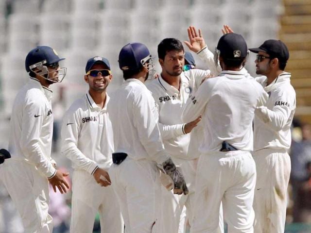 Pragyan Ojha celebrates with teammates the wicket of Australia's N Lyon on the final day of the 3rd cricket test match in Mohali on Monday. (PTI Photo)