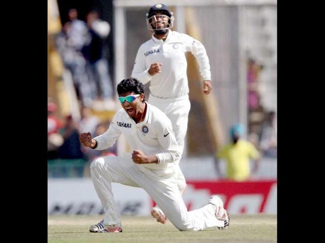 R Jadeja celebrates after taking the wicket of Australian player Phillip Hughes on the final day of the third Test match in Mohali. (PTI Photo)