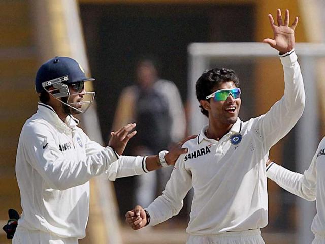 R Jadeja with M Vijay celebrates the wicket of Australian player Michael Clarke on the final day of the third Test match in Mohali. (PTI Photo)