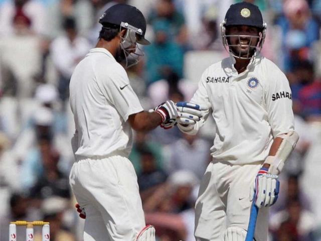 M Vijay and C Pujara congratulate each other on the final day of the 3rd Test match in Mohali on Monday. (PTI Photo)