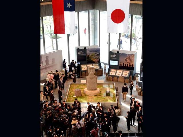 Journalists and visitors gather to see the new "Moai" statue, modelled on the mysterious carvings at Easter Island, presented to the tsunami-devastated town of Minamisanriku during its preview in Tokyo. AFP