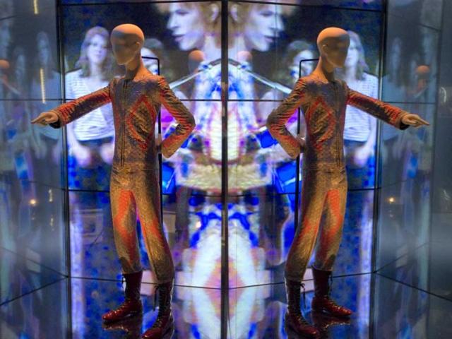 A reflection of the costume that David Bowie wore as Ziggy Stardust on tour and during a performance of 'Starman' on British pop music show Top of The Pops, is photographed as part of a retrospective David Bowie exhibition, entitled David Bowie Is, at the V&A Museum in west London. (AP Photo)