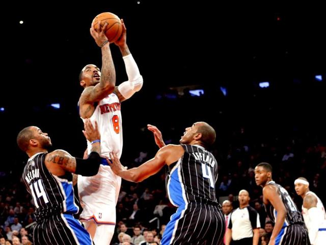 New York Knicks JR Smith shoots over Orlando Magic Jameer Nelson and Arron Afflalo in NBA game in New York. (Reuters)