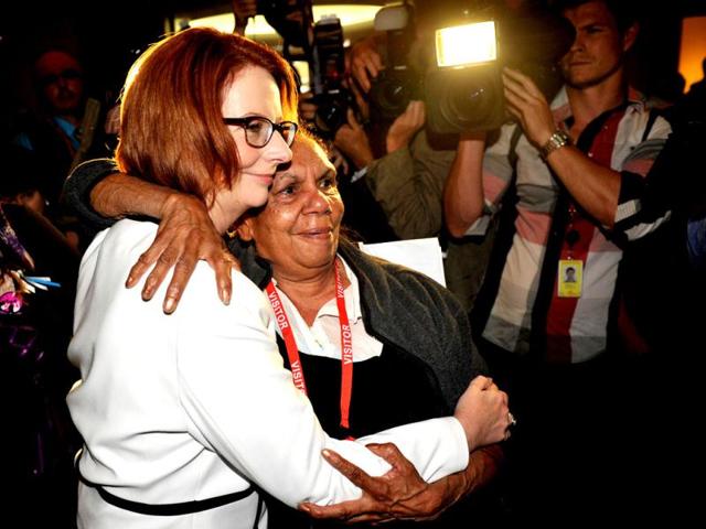 Australia's Prime Minister Julia Gillard (L) is embraced by a woman during a ceremony on the National Apology for Forced Adoptions at Parliament House in Canberra. AFP