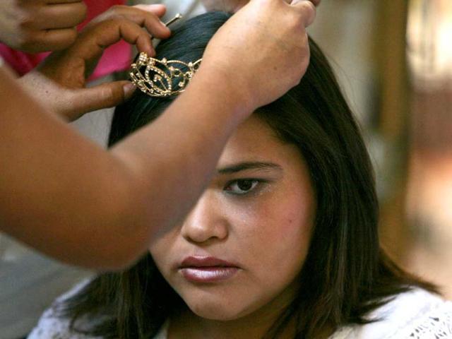 A girl gets her crown adjusted before participating in the "Miss Spring with Disabilities" beauty contest in Tlaquepaque. Reuters photo