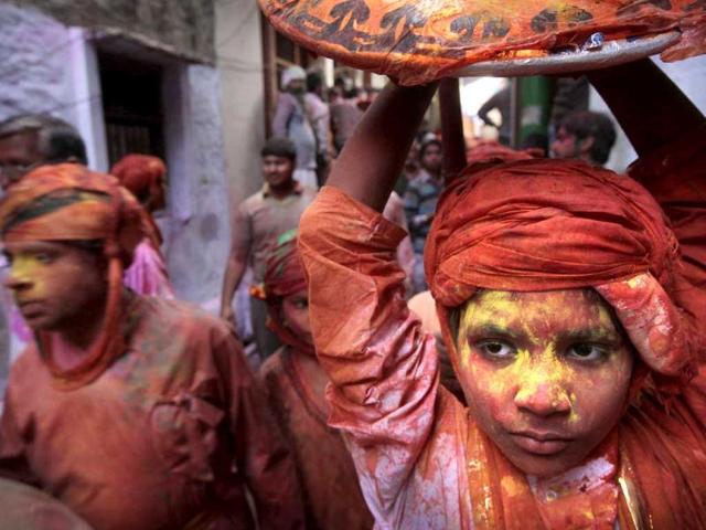 A young boy from Nandgaon soaked in water and colors arrives in Barsana village during the Lathmar Holy festival in Barsana. (AP)