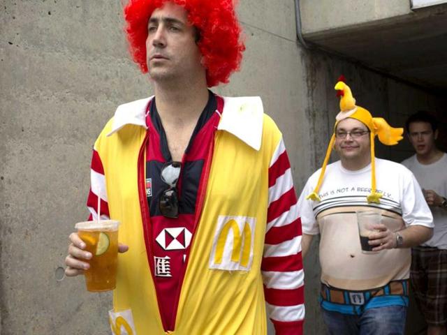 A rugby fan in a Ronald McDonald costume walks on the spectators' stand during the second day of the three-day Hong Kong Sevens rugby tournament. Reuters photo