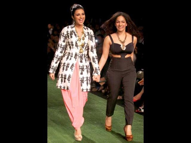 Parineeti Chopra walks the ramp alongwith designer Masaba displaying her collection on the first day of Lakme Fashion Week 2013 in Mumbai on Friday. (PTI Photo)